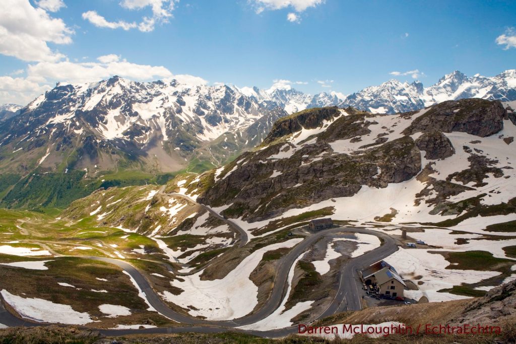 Alpine mountain scene with snow over the Col du Galibier in France with a blue sky.
